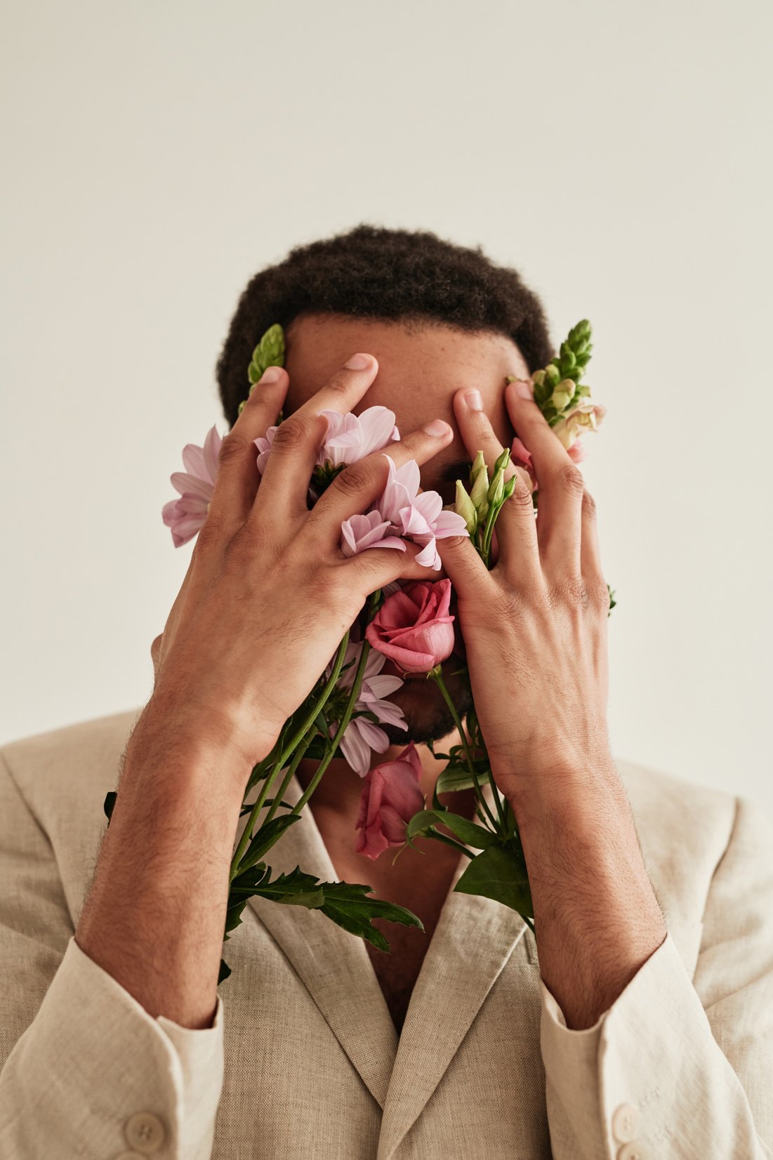 Man Covering His Face with Flowers